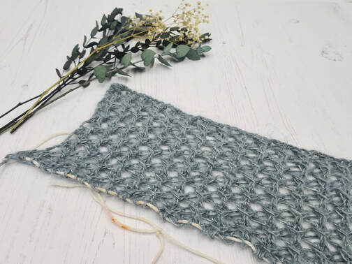 Hand knitted lace for shoulders of a cardigan
